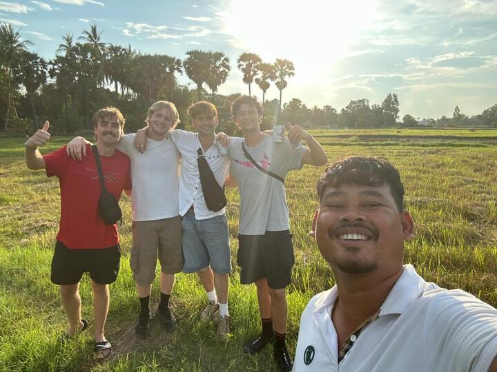 Cambodian family working in rice fields representing community-based tourism